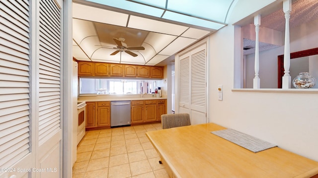 kitchen with ceiling fan, sink, light tile patterned floors, dishwasher, and white stove