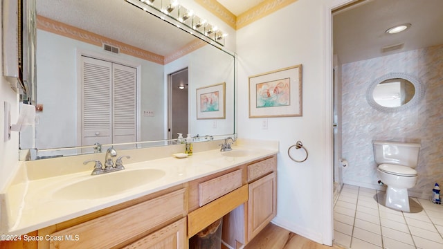 bathroom featuring tile patterned flooring, vanity, and toilet