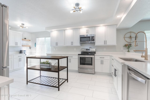 kitchen featuring white cabinetry, sink, a textured ceiling, and appliances with stainless steel finishes