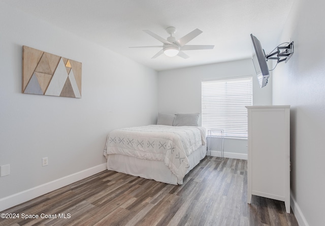 bedroom featuring ceiling fan and dark wood-type flooring