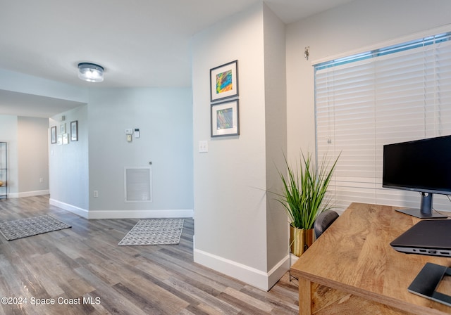 hall with hardwood / wood-style flooring