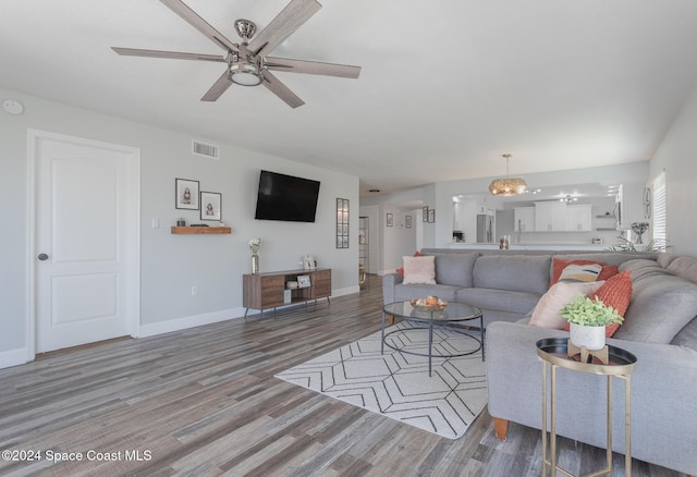 living room with ceiling fan and hardwood / wood-style flooring