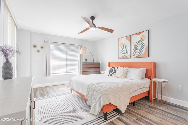 bedroom with ceiling fan and wood-type flooring