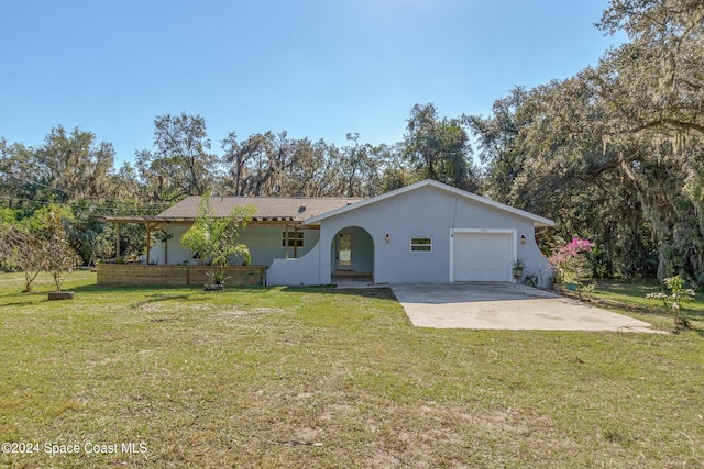 ranch-style home with a garage and a front lawn