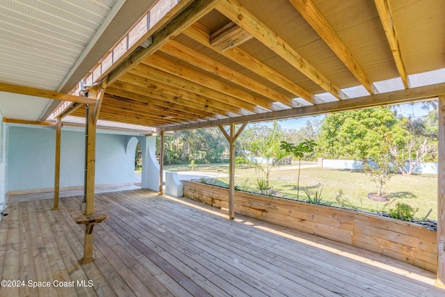 wooden terrace featuring a lawn