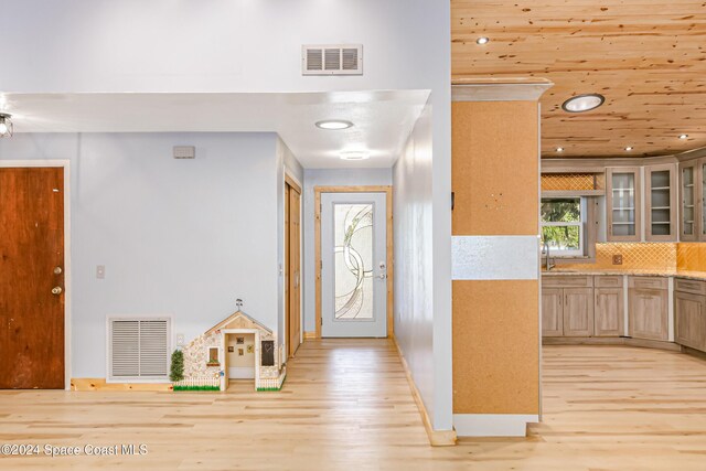 entryway with sink and light wood-type flooring