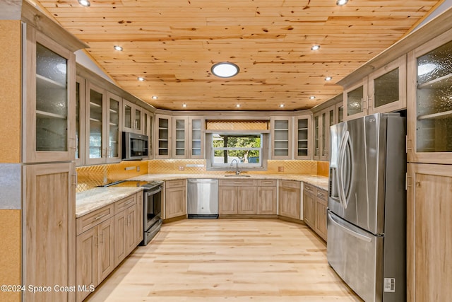 kitchen with wood ceiling, appliances with stainless steel finishes, light stone counters, light brown cabinetry, and light wood-type flooring