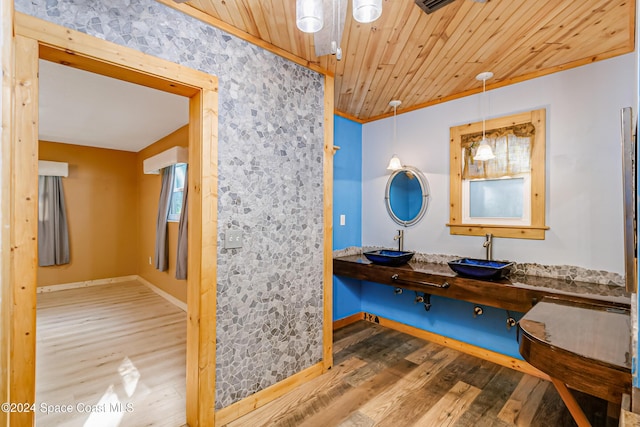 bathroom with wood-type flooring, sink, wooden ceiling, and ornamental molding