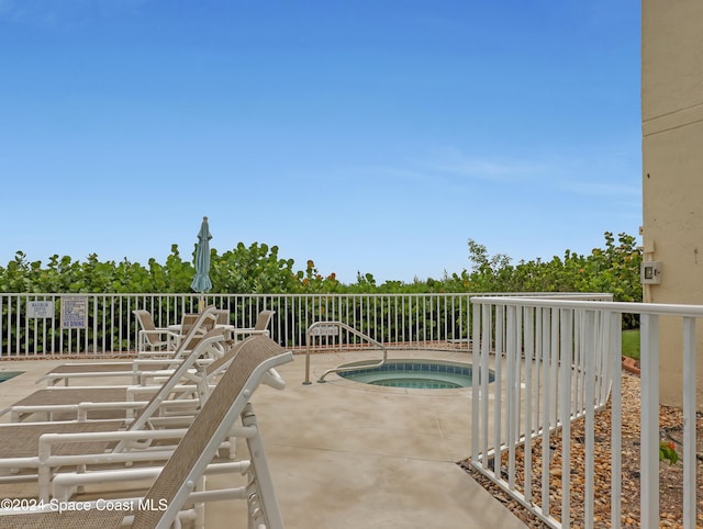 view of swimming pool featuring a community hot tub and a patio