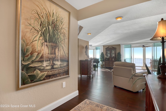 living room with a textured ceiling, dark hardwood / wood-style flooring, and vaulted ceiling