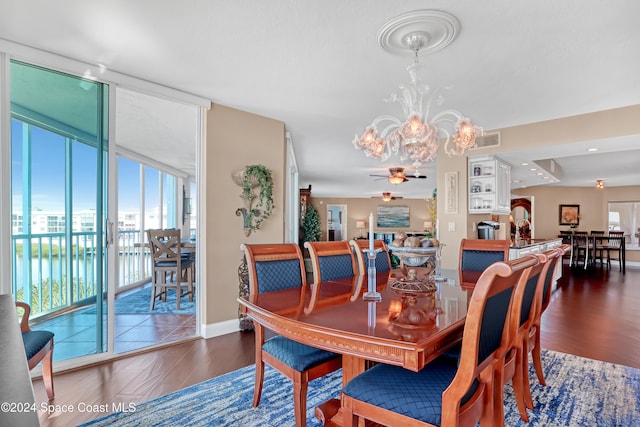 dining space featuring ceiling fan and dark hardwood / wood-style flooring