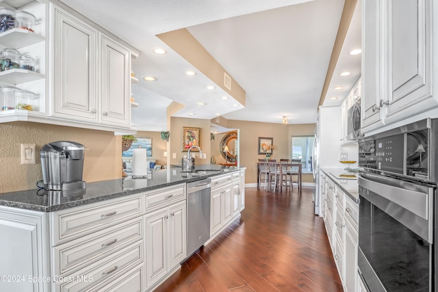 kitchen featuring white cabinetry, sink, stainless steel appliances, and dark hardwood / wood-style floors