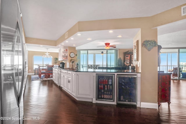 interior space featuring stainless steel refrigerator, dark hardwood / wood-style floors, a healthy amount of sunlight, and wine cooler