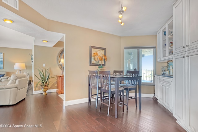 dining area with dark hardwood / wood-style floors