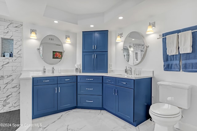 bathroom with vanity, toilet, walk in shower, and a tray ceiling