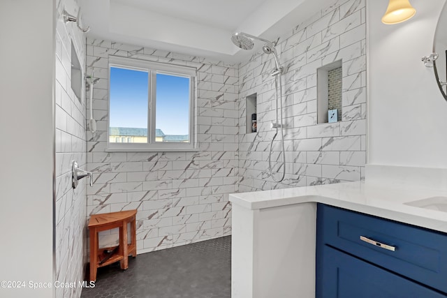 bathroom featuring vanity, walk in shower, and tile walls