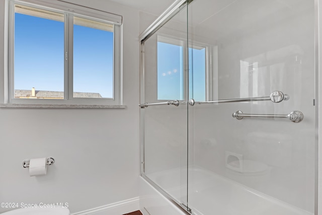 bathroom with bath / shower combo with glass door