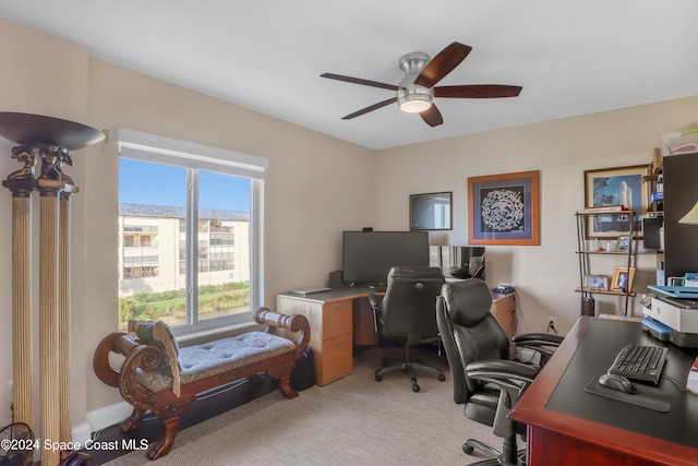 carpeted home office with ceiling fan