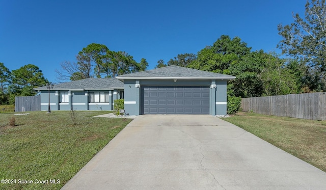 view of front of house with a garage and a front lawn