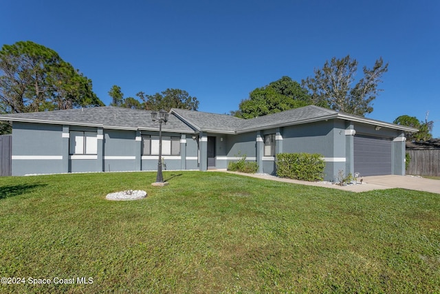 ranch-style house featuring a garage and a front yard