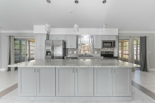 kitchen with tasteful backsplash, crown molding, pendant lighting, and appliances with stainless steel finishes