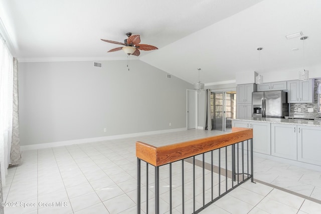 kitchen with vaulted ceiling, gray cabinetry, hanging light fixtures, and stainless steel refrigerator with ice dispenser