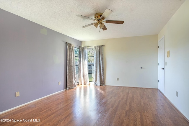 spare room with ceiling fan, a textured ceiling, and hardwood / wood-style flooring