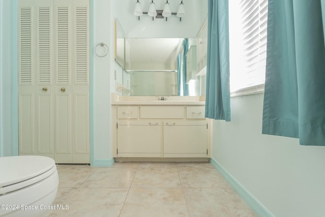 bathroom featuring tile patterned flooring, vanity, and toilet