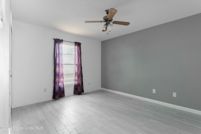 spare room featuring ceiling fan, a textured ceiling, and light hardwood / wood-style flooring