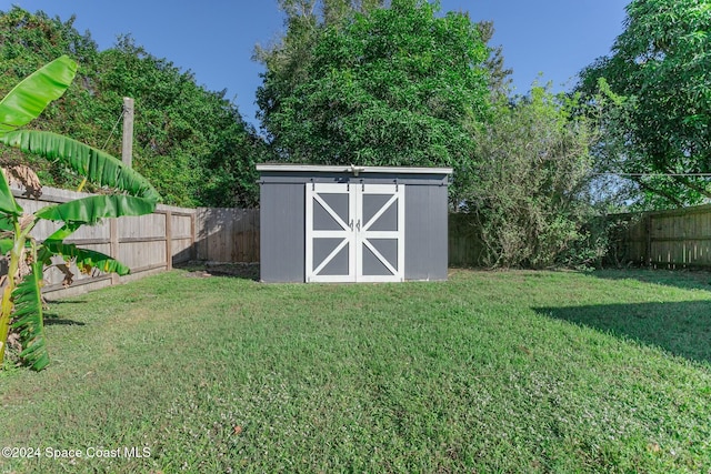 view of outbuilding with a yard