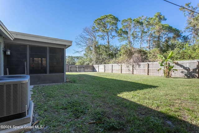 view of yard with a sunroom and cooling unit