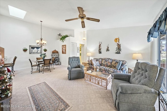 carpeted living room featuring ceiling fan with notable chandelier and a skylight