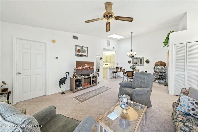 living room featuring ceiling fan with notable chandelier and light carpet