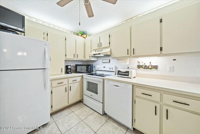 kitchen featuring cream cabinets, white appliances, and custom exhaust hood