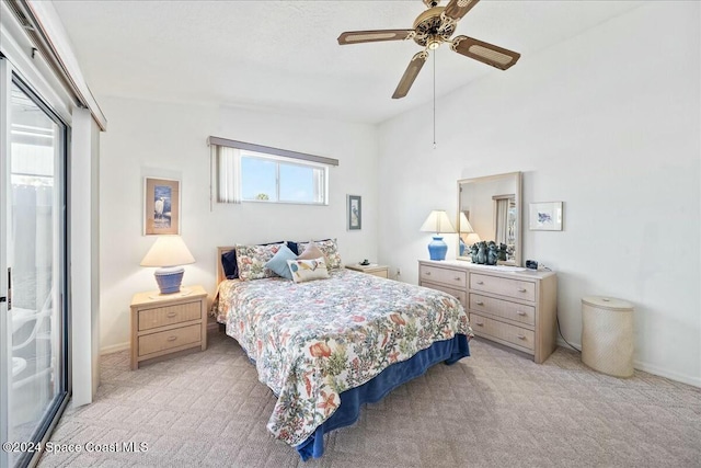 bedroom with ceiling fan, light carpet, and vaulted ceiling