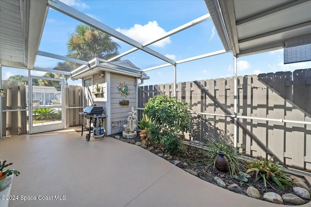 view of patio featuring a lanai