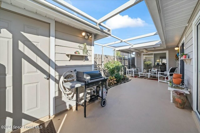 view of patio featuring area for grilling and a lanai