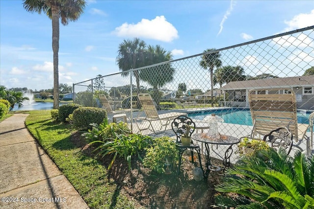 view of swimming pool featuring a water view