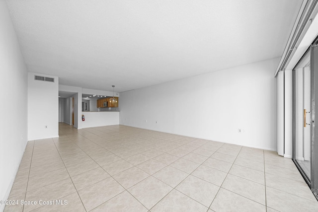 unfurnished living room with light tile patterned floors