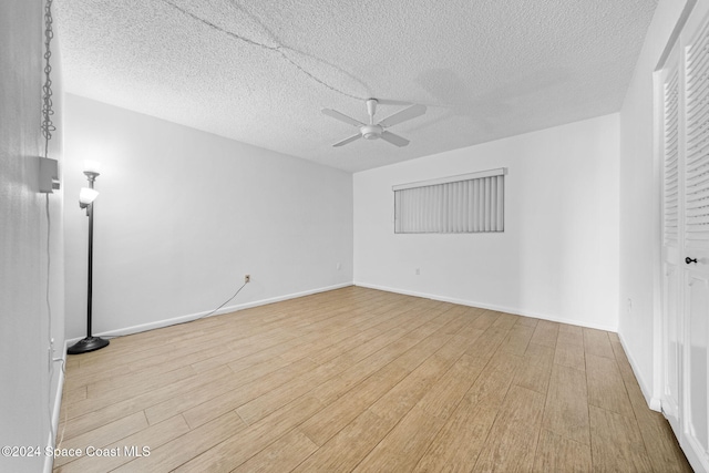 unfurnished room featuring ceiling fan, light hardwood / wood-style floors, and a textured ceiling