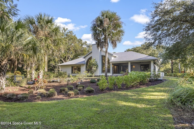 exterior space featuring a yard and a sunroom