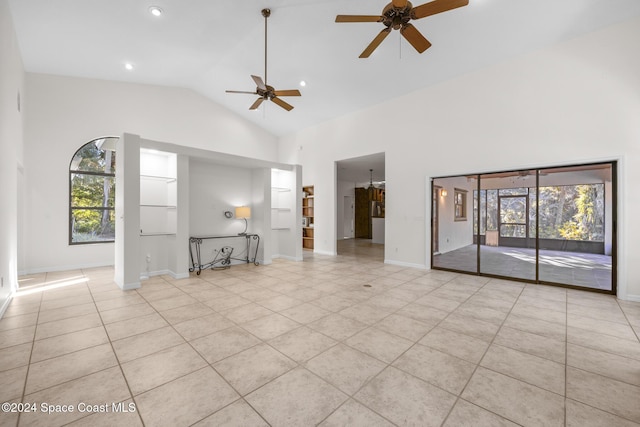 unfurnished living room with ceiling fan, light tile patterned floors, and high vaulted ceiling