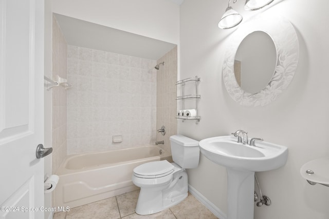 bathroom with tile patterned flooring, tiled shower / bath combo, and toilet