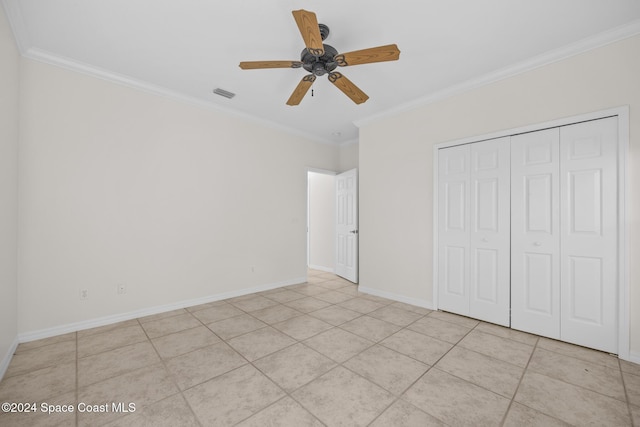 unfurnished bedroom featuring light tile patterned floors, a closet, ceiling fan, and ornamental molding