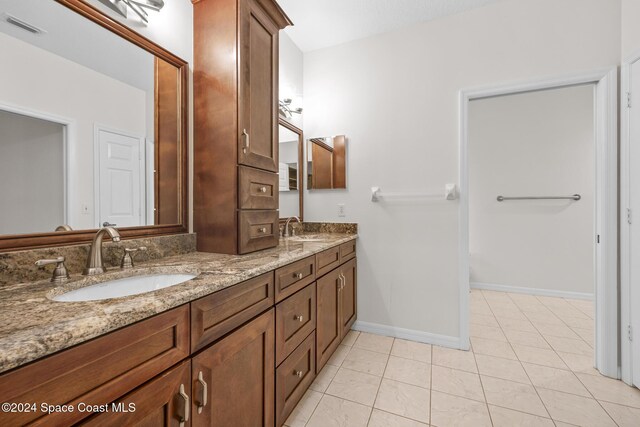 bathroom featuring tile patterned flooring and vanity