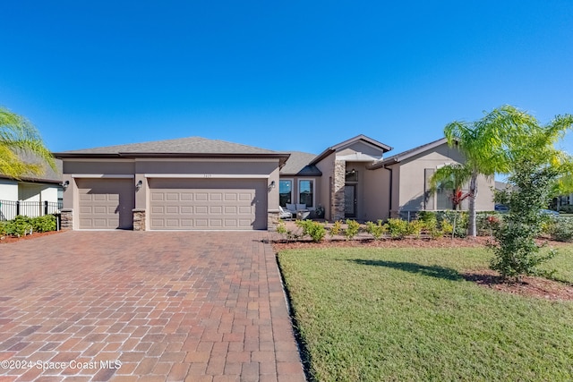 view of front of home featuring a garage and a front lawn