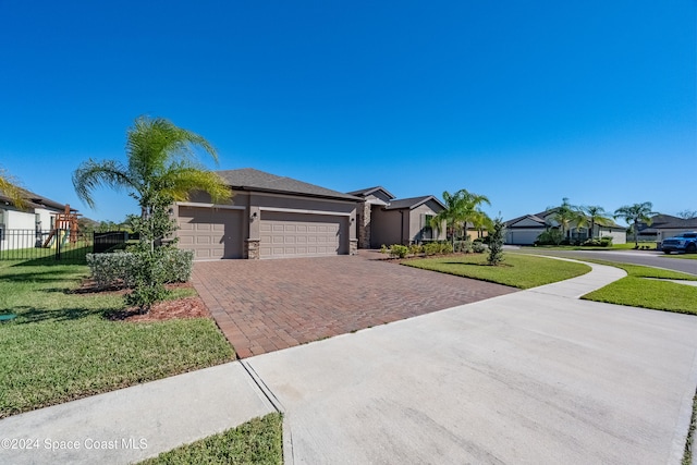 view of front of home featuring a garage and a front yard