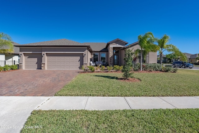 view of front of house with a garage and a front yard