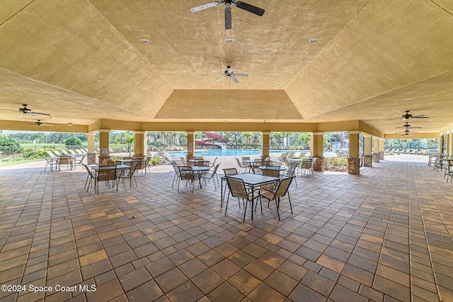 view of patio / terrace with ceiling fan and a community pool