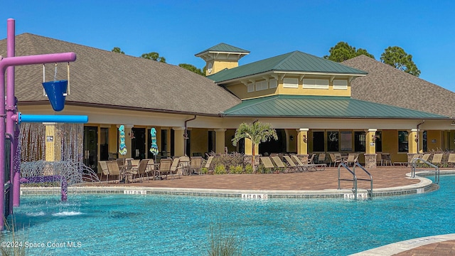 view of pool with pool water feature and a patio area